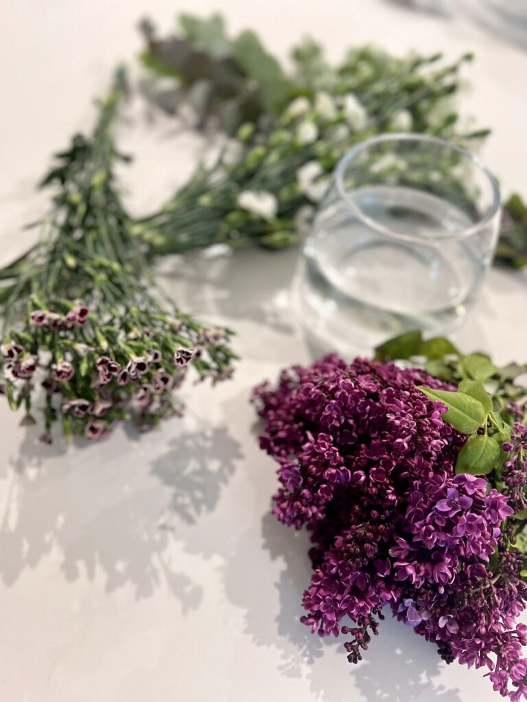 Materials needed for this arrangement include a vase and four types of flowers