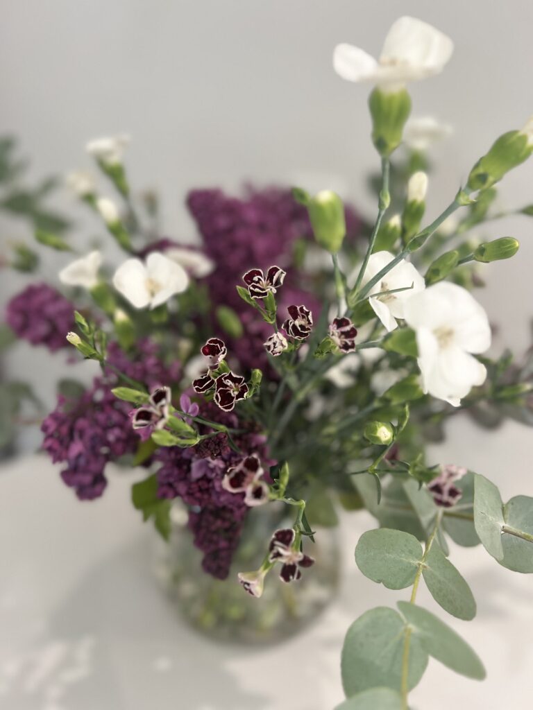 The arrangement you will be creating: French lilac, eucalyptus, and dianthus in a glass vase