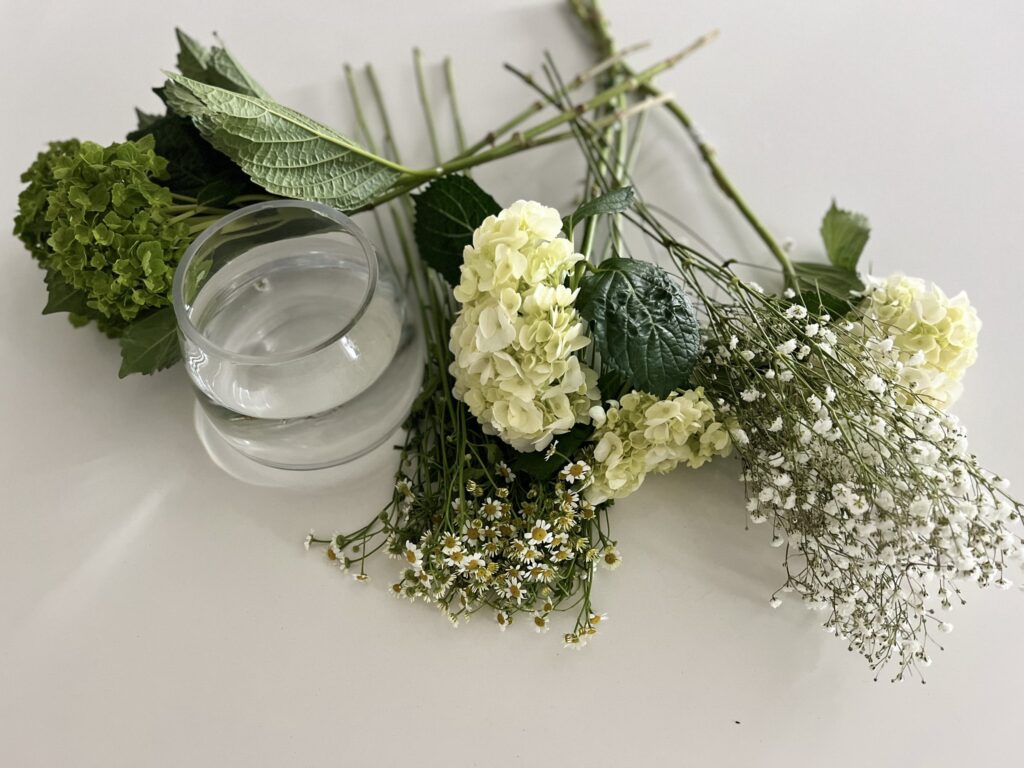 Materials needed for this arrangement include a vase and four types of flowers