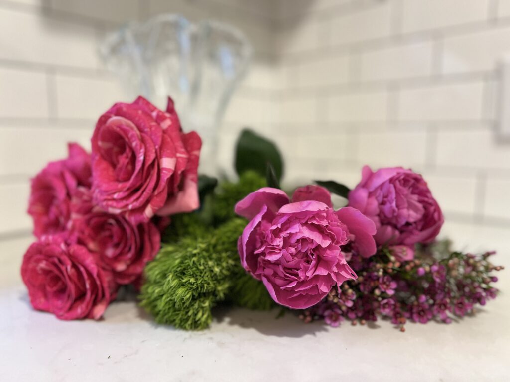 You will need: pink striped roses, peonies, green ball dianthus, and waxflower